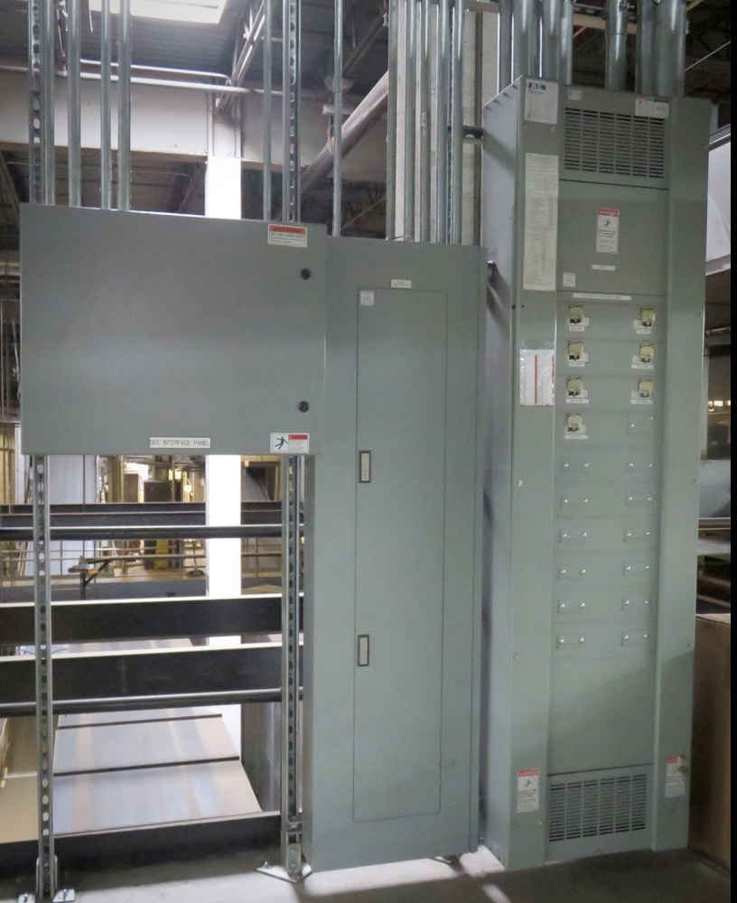 Electrical panel and breaker box in an industrial setting Photo of an electrical panel and breaker box in an industrial setting